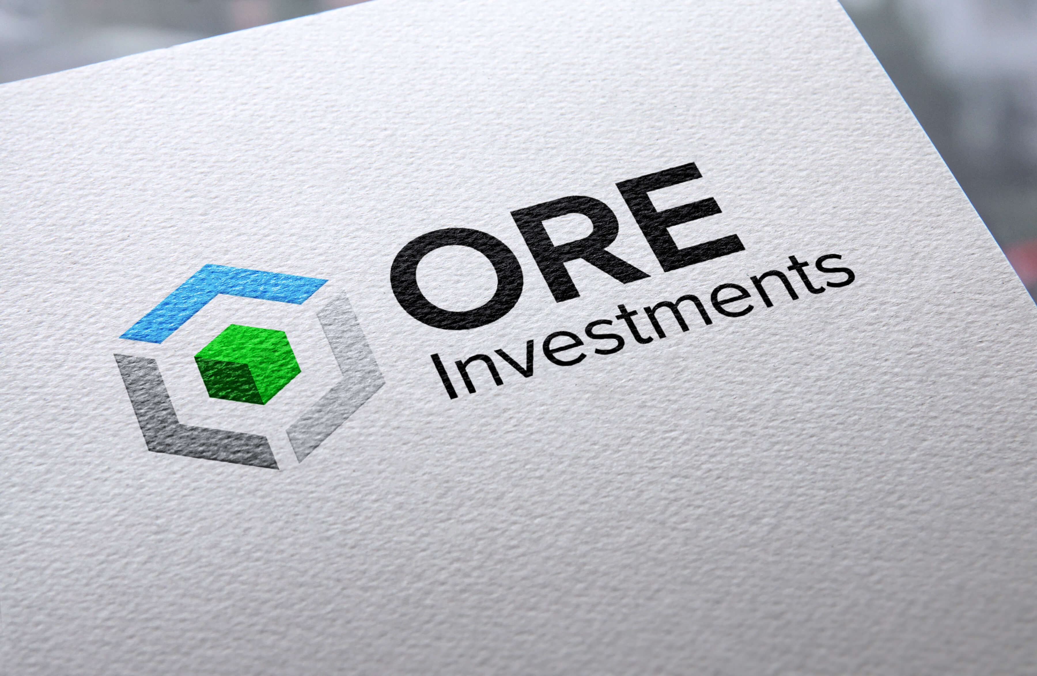 Close-up ORE Investments logo design printed on textured paper
